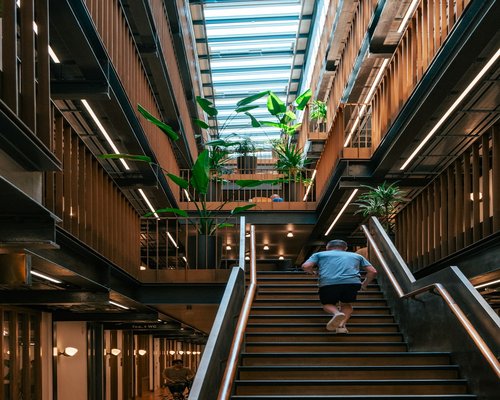 Person walking up the stairs in office building